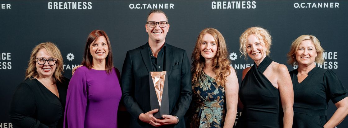 ACE employee recognition leaders accepting the Breakthrough Award at O.C. Tanner’s Influence Greatness conference.