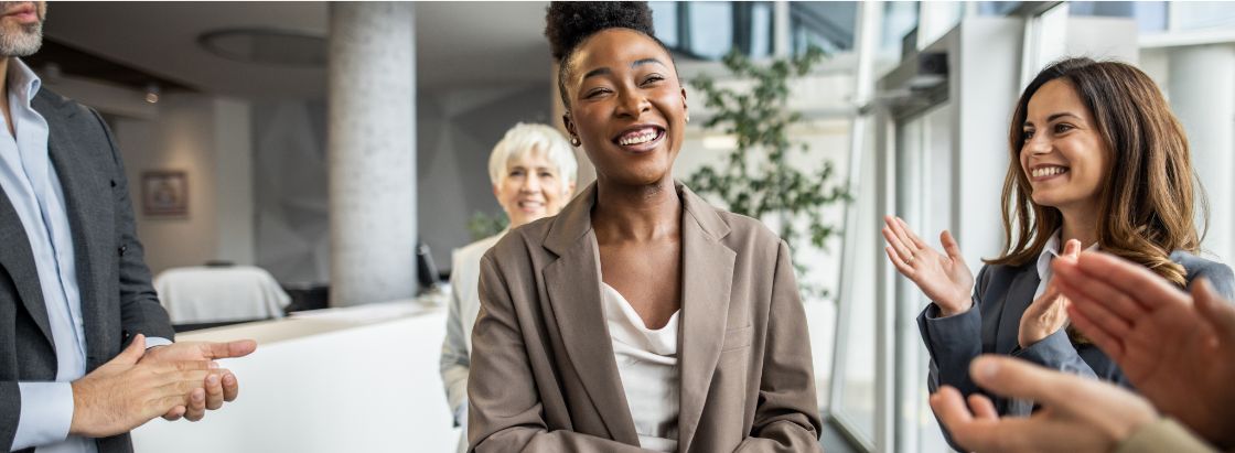 A team applauding a coworker