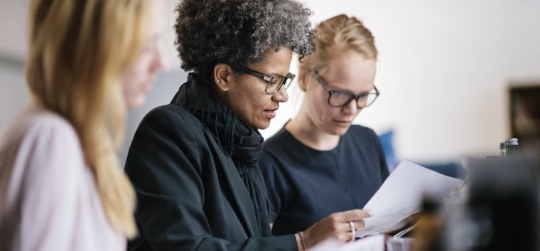 Employees reviewing paperwork