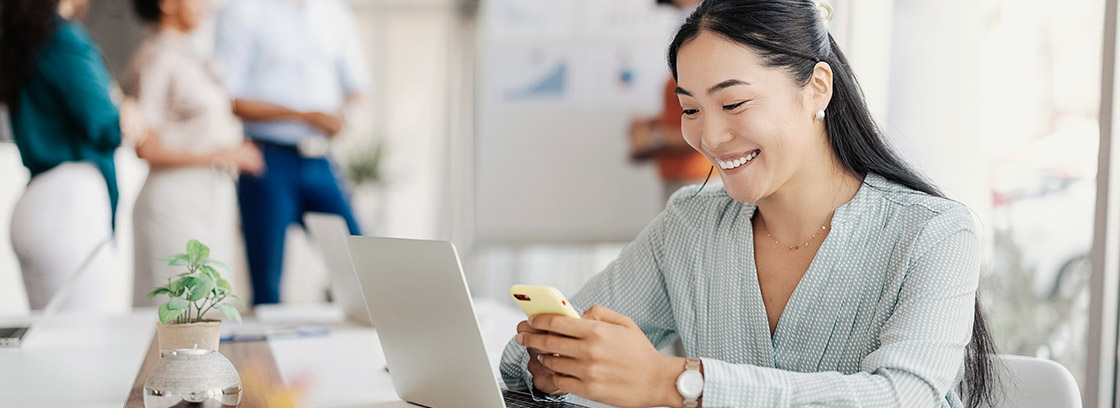 A businesswoman using her phone in an office