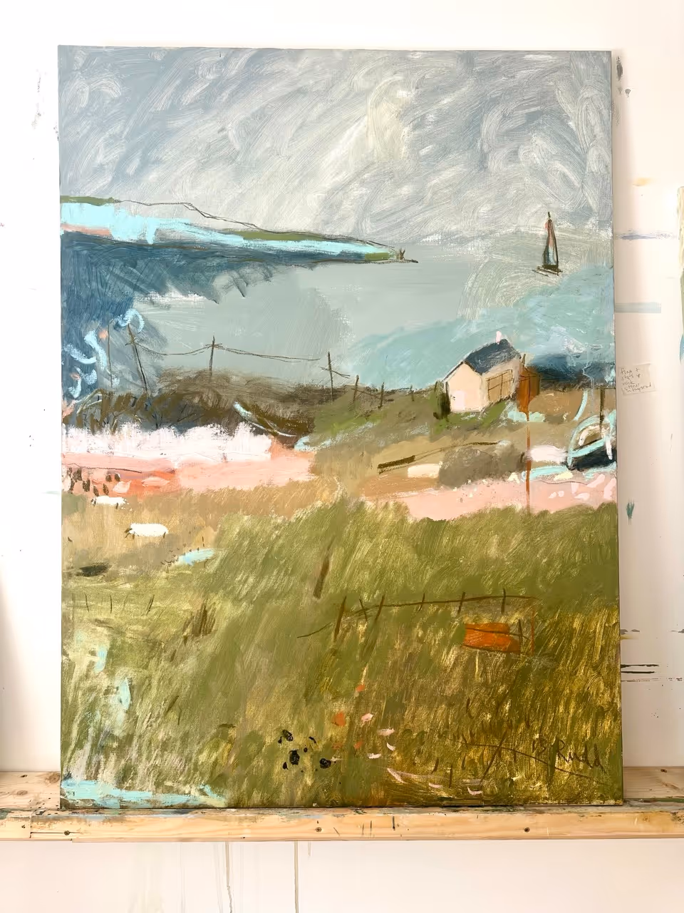 Impressionist painting of a house near water with sailboat, grassy fields, and cloudy sky.