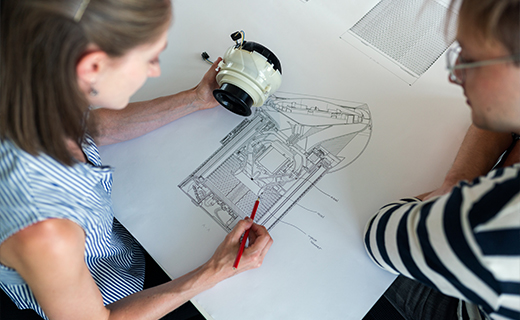 Engineers chatting through a design sketch