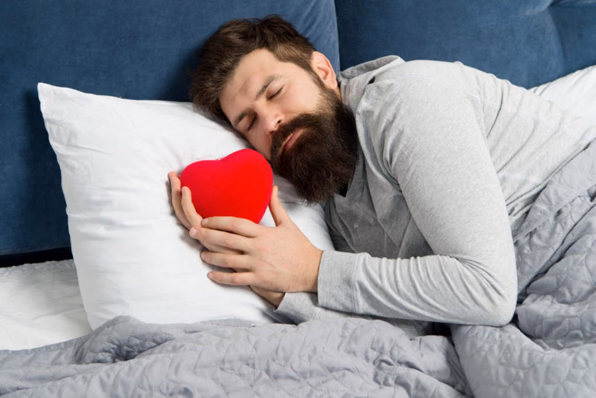 Man Smiling in Red Sweatshirt Making Heart Sign with Hands - 1280x720
