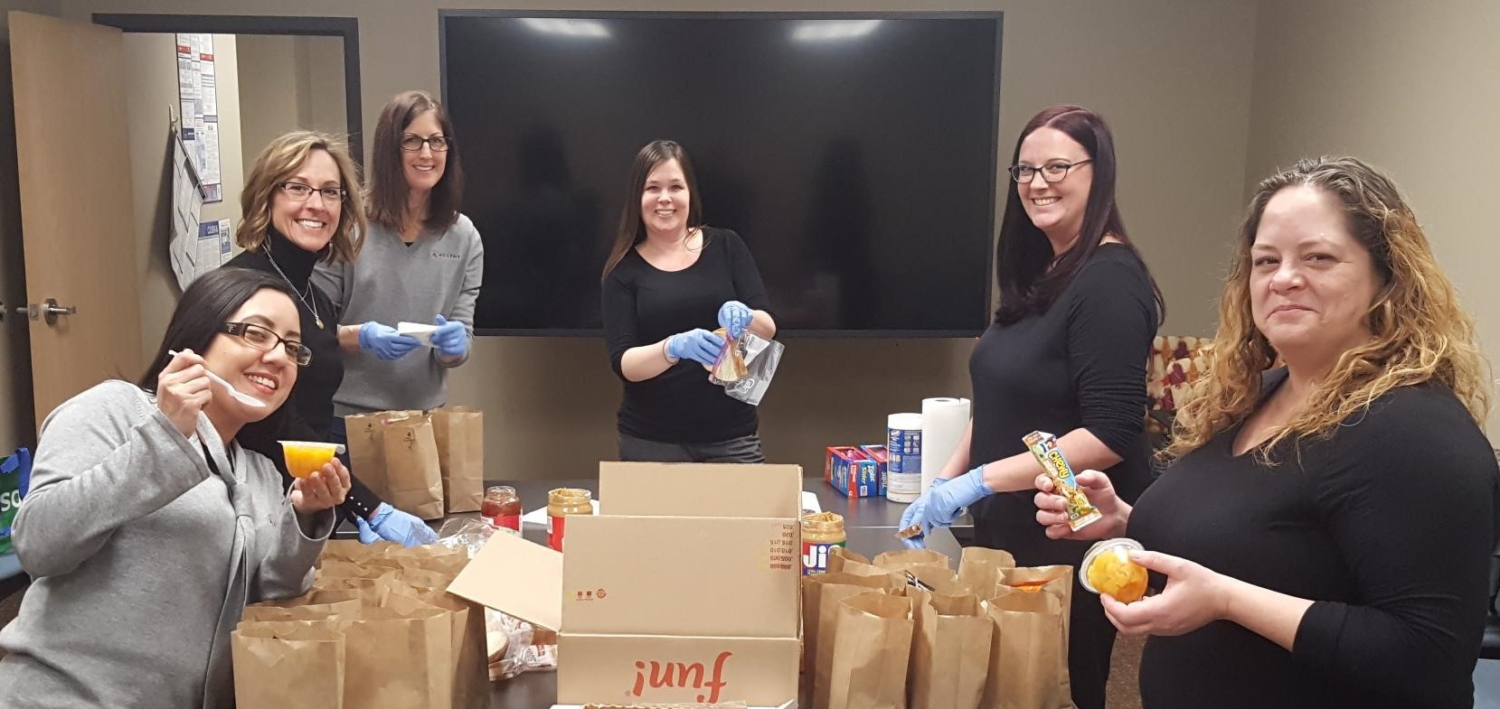 ADVENT team members assembling bag meals for Street Angels
