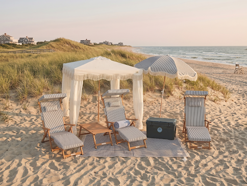Outdoor wooden deck with a pool, a Chandon Garden Spritz cart, cushioned chairs with striped pillows, and an orange umbrella.