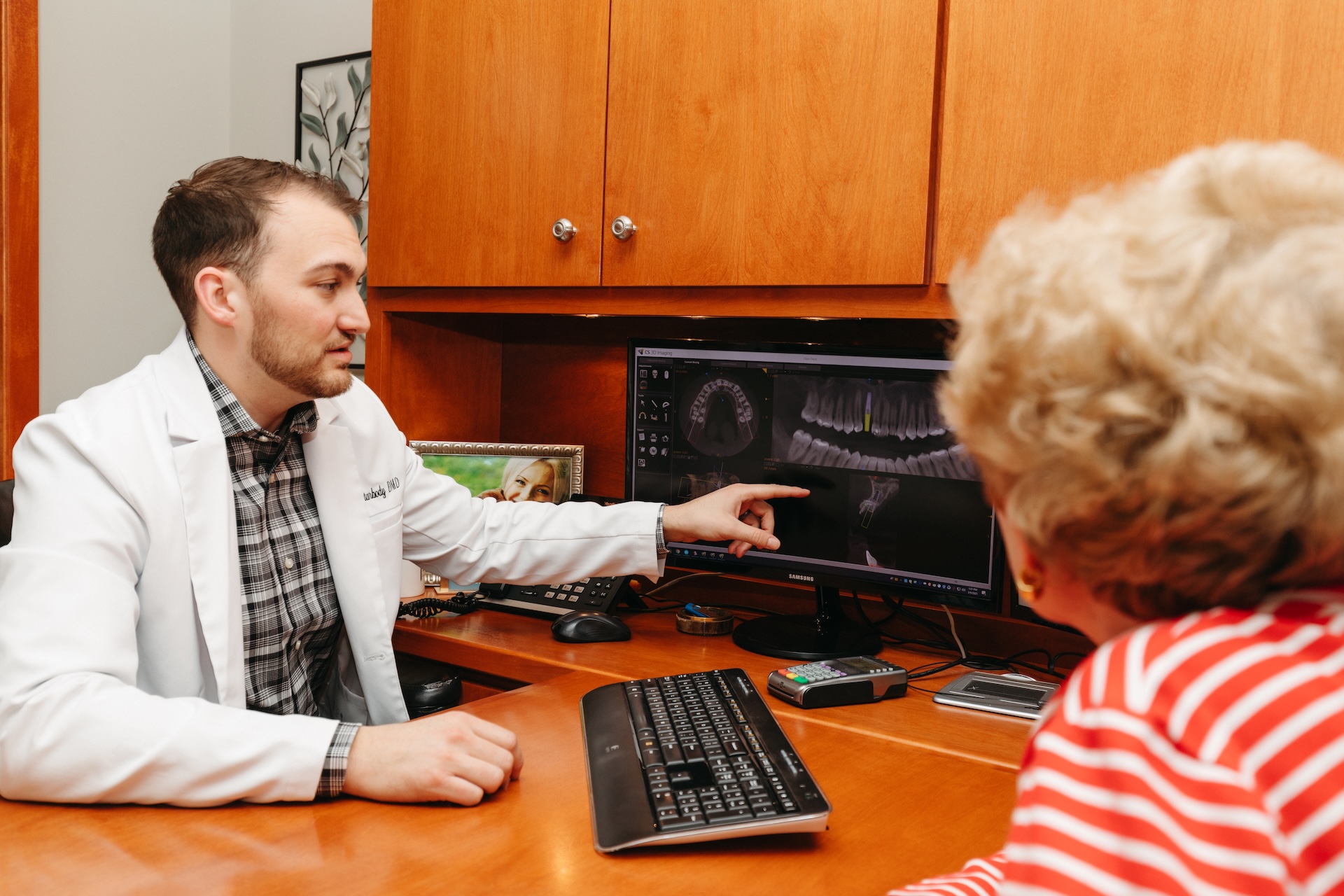 Dr. Michael Starbody shows Elderly Woman a Diagram for Her Dental Implant on the Computer