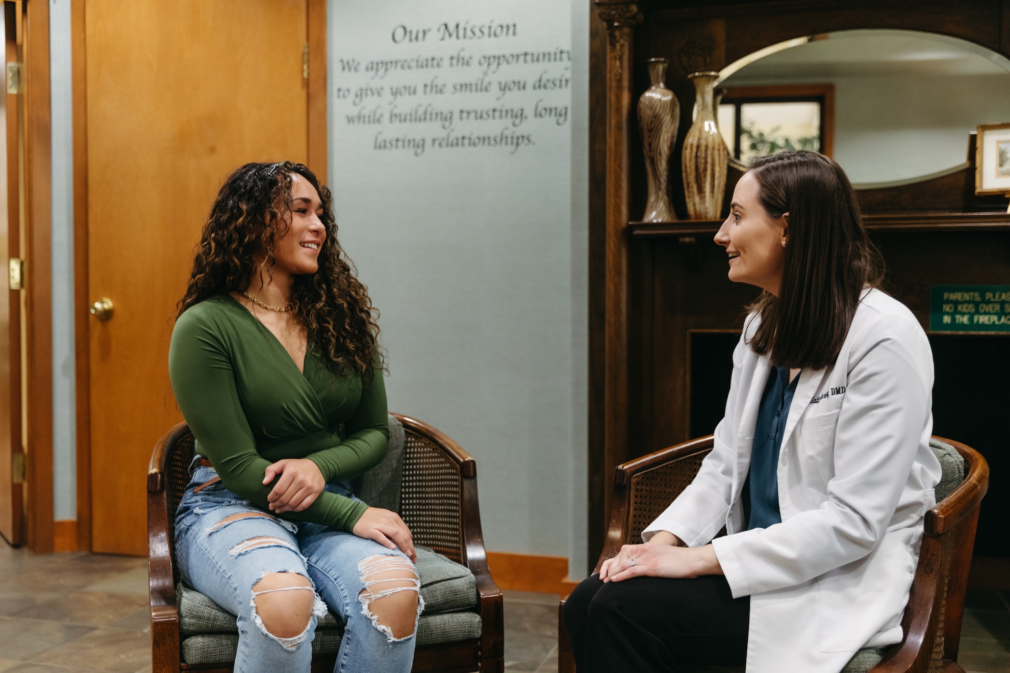 Dentist and patient sitting and discussing oral health.