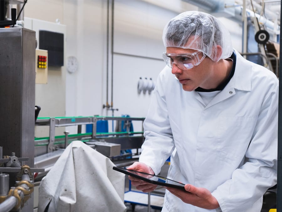Operator inspecting factory equipment