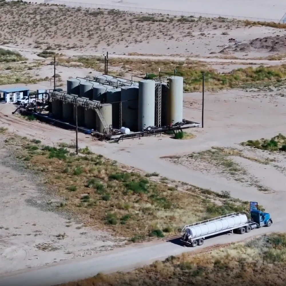 A fluid hauling truck pulling up to a salt water disposal (SWD) to dispose of produced water.