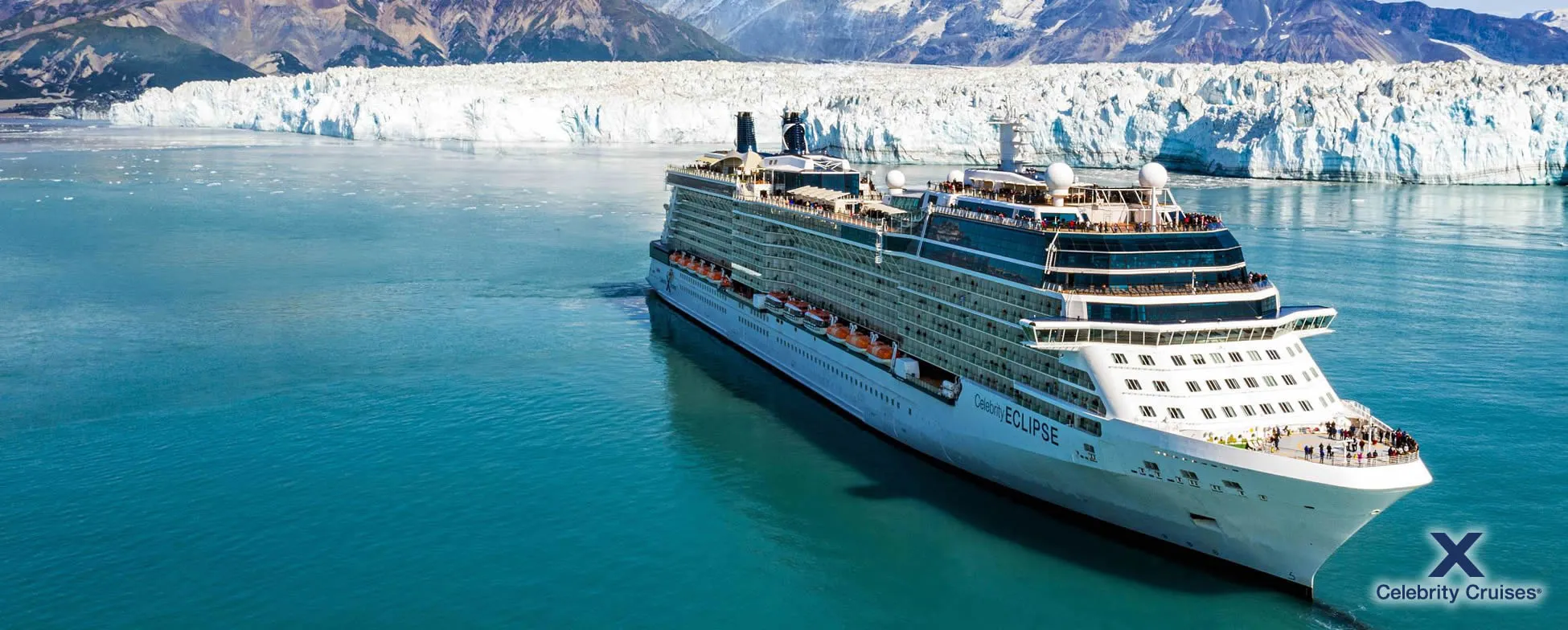 Cruise ship sailing near massive glacier in turquoise Alaskan waters