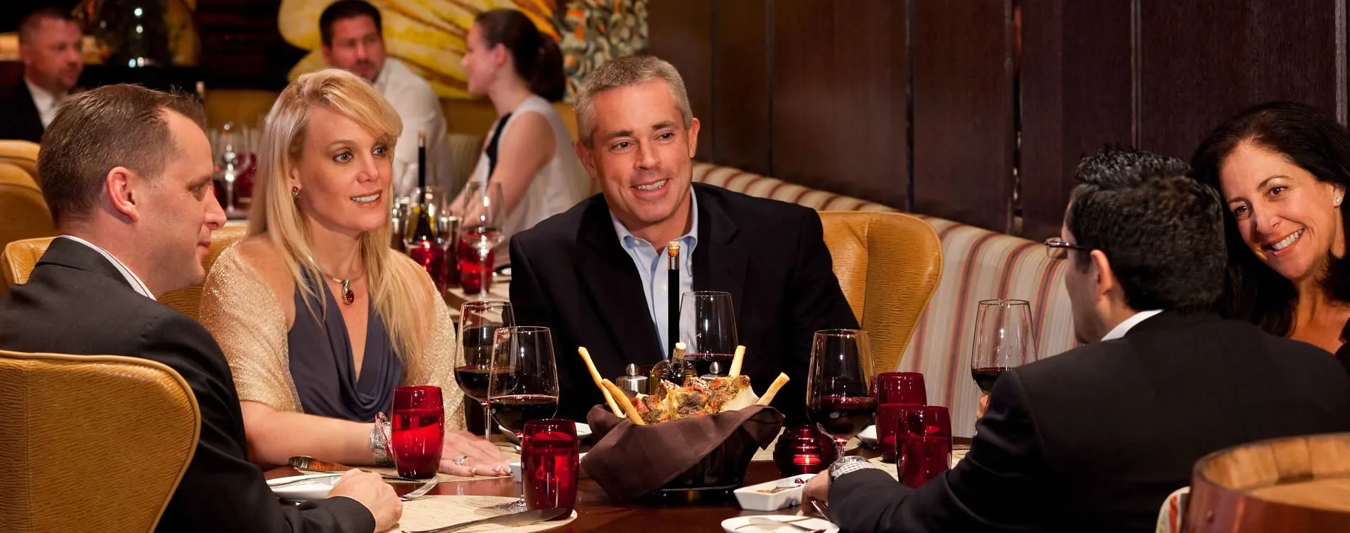 Business professionals enjoying dinner and wine at an elegant restaurant
