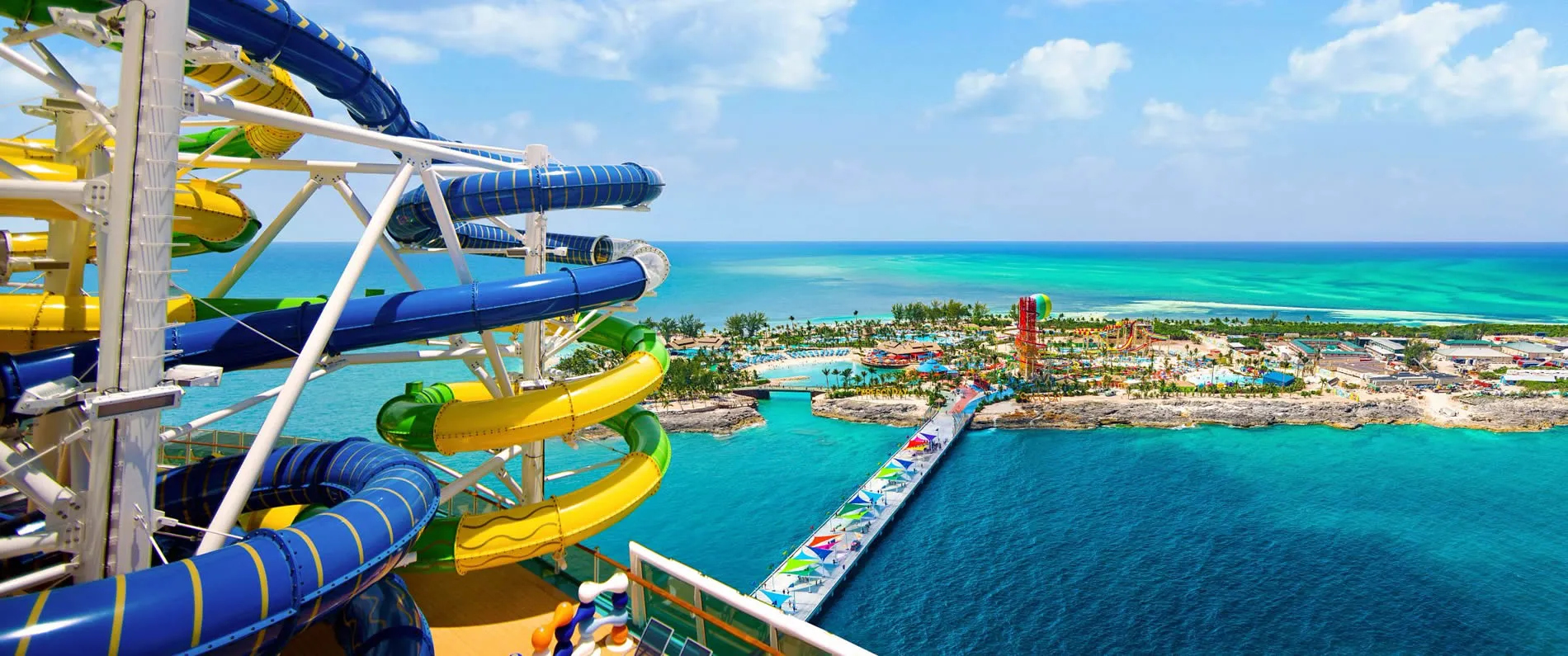 Colorful water slides overlooking tropical ocean and waterpark