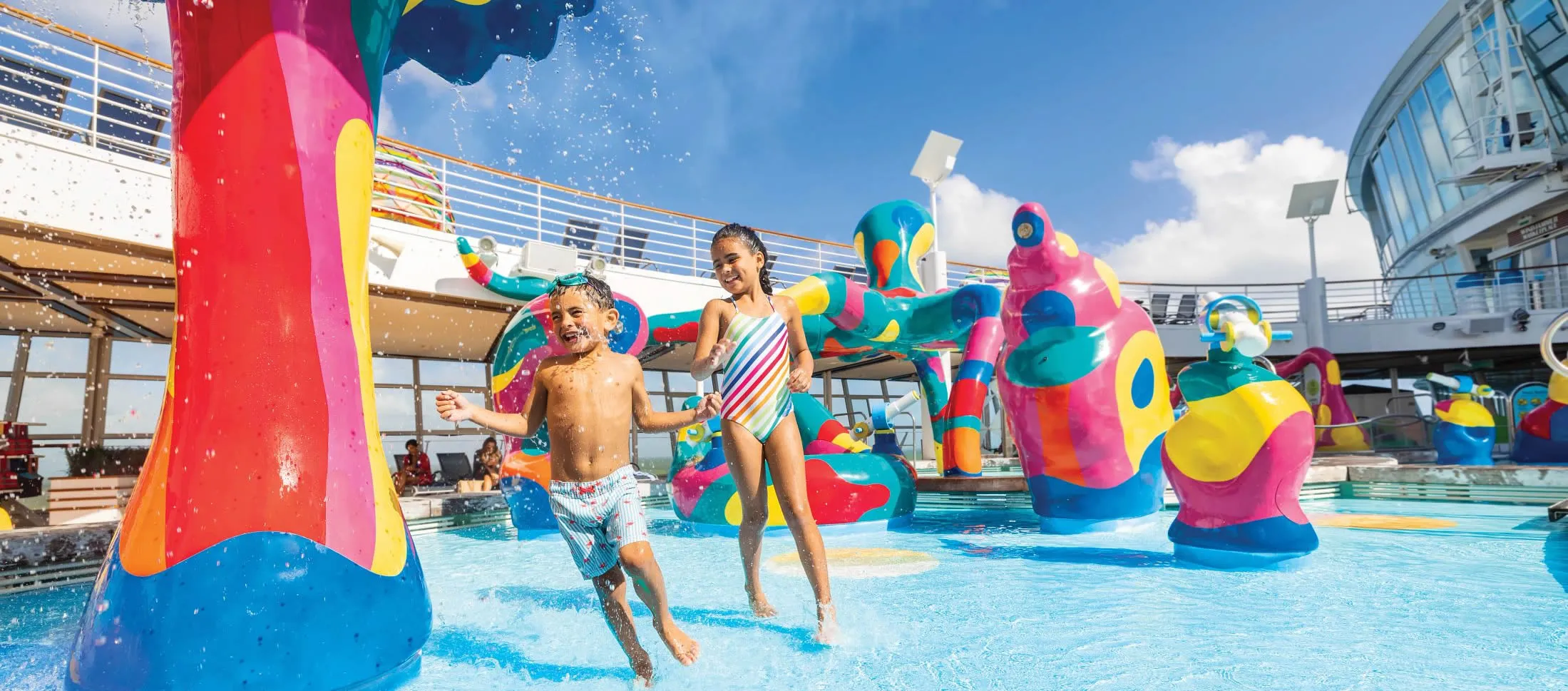 Children playing in colorful water park with inflatable toys on cruise ship