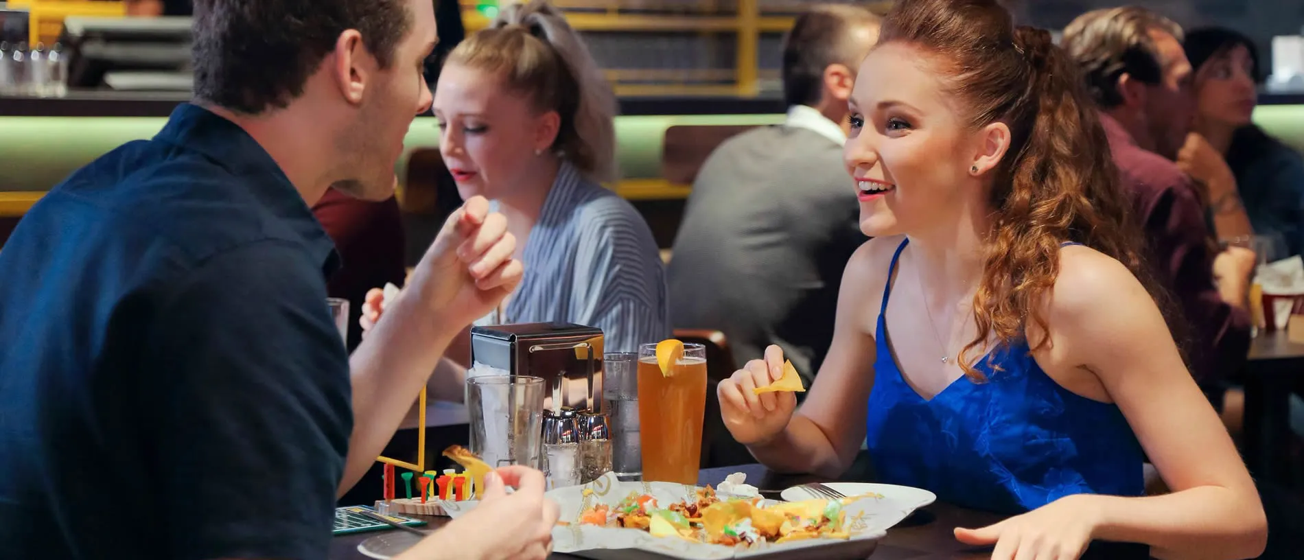 Friends enjoying drinks and food at a casual restaurant together