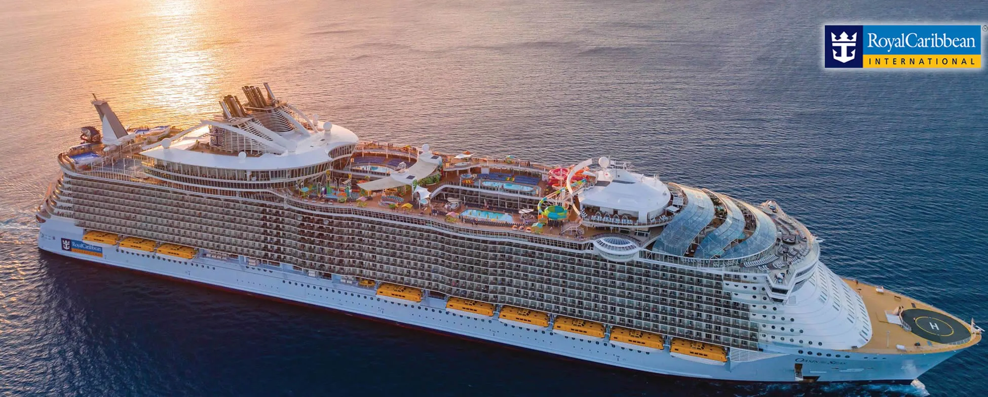 Large Royal Caribbean cruise ship sailing at sunset with colorful decks