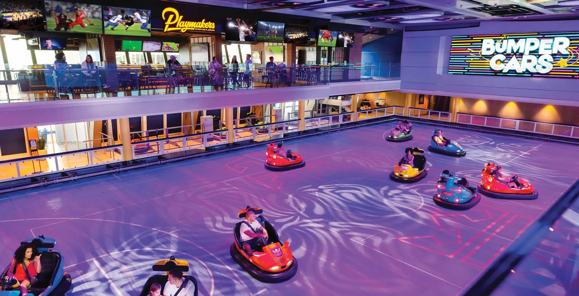 Colorful bumper cars on a purple rink with people enjoying ride