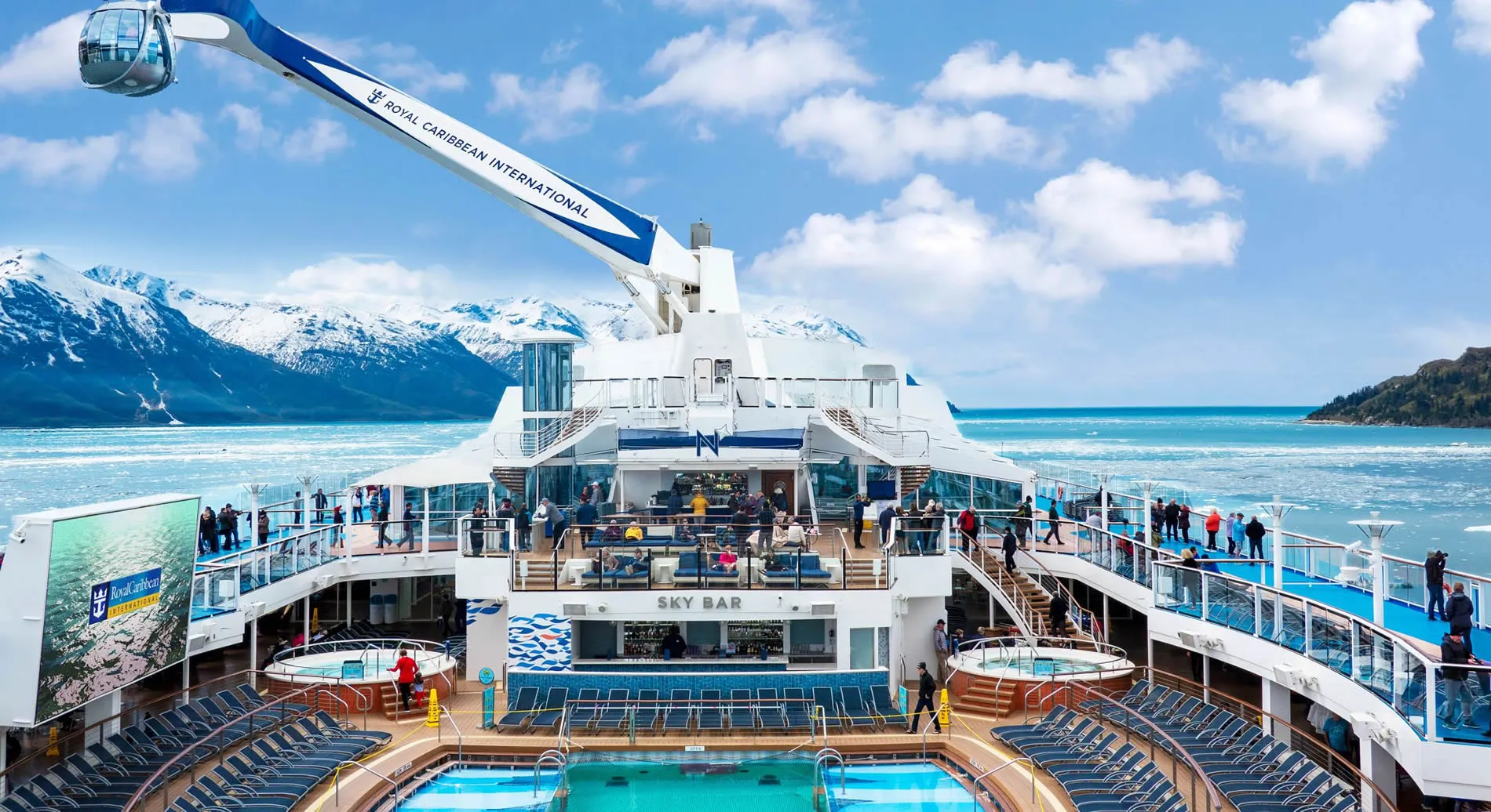 Royal Caribbean cruise ship sailing through scenic Alaskan glacial waters