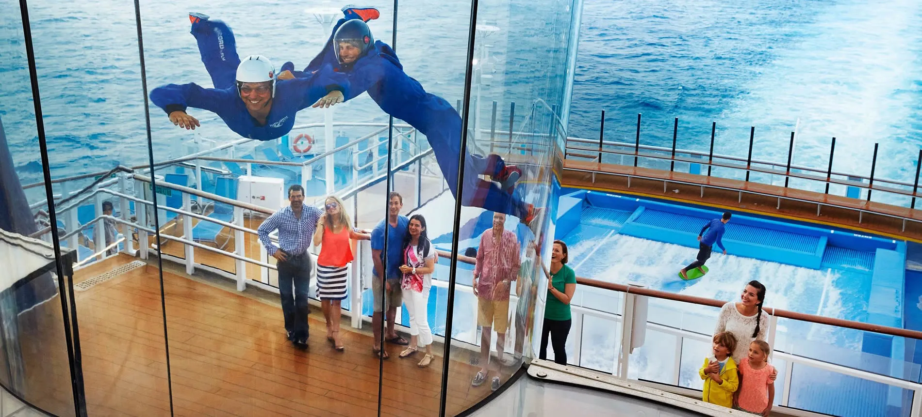 Passengers watching indoor skydiving on cruise ship's deck