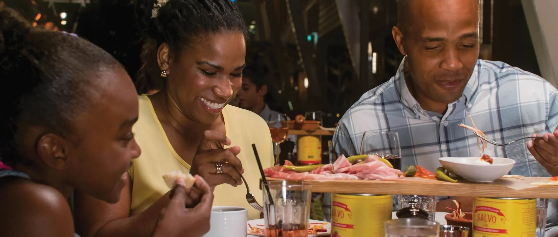 Friends enjoying charcuterie board and drinks at a restaurant