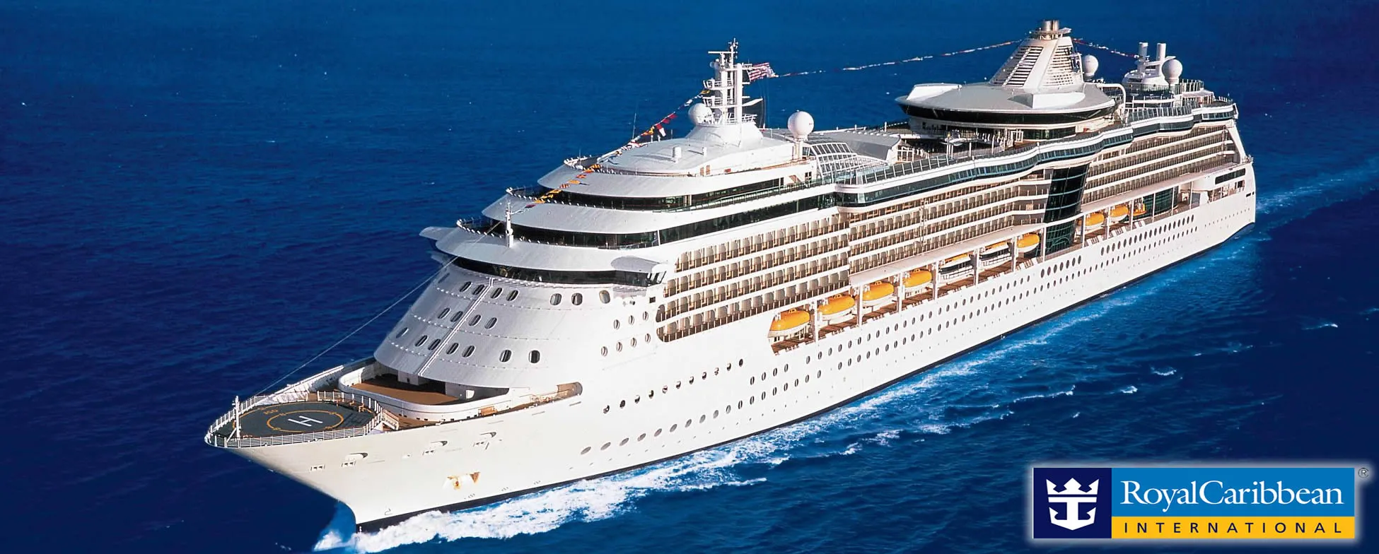 Large white Royal Caribbean cruise ship sailing on deep blue ocean