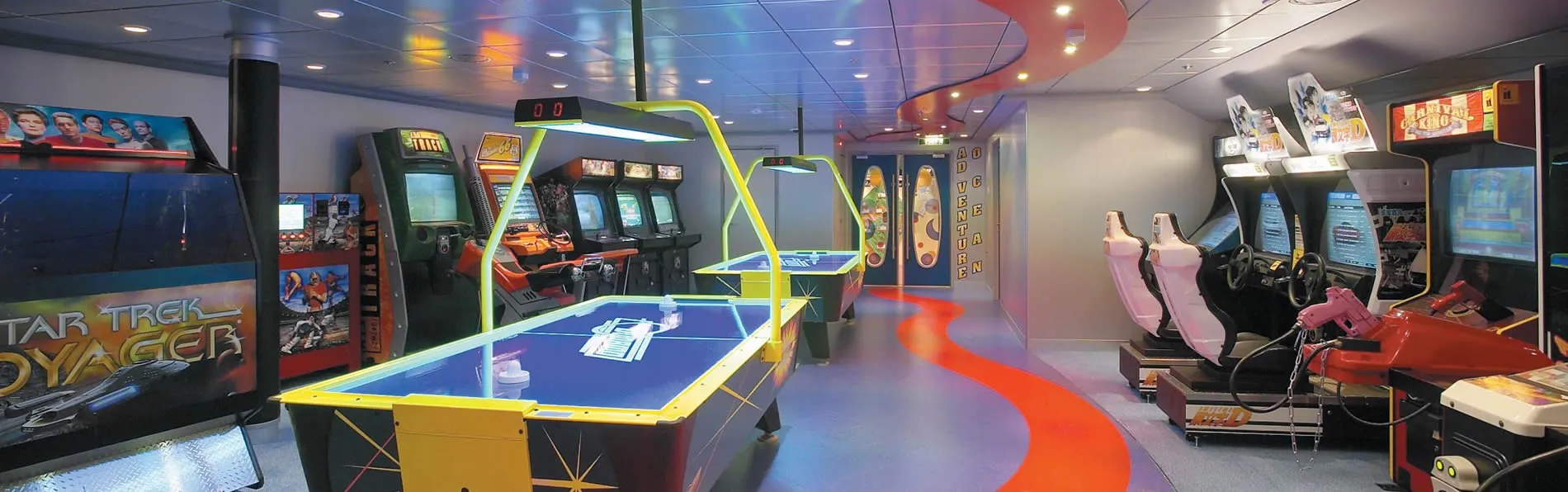 Colorful arcade room with Star Trek Voyager game machines and air hockey