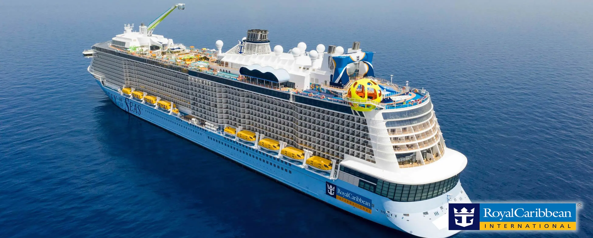 Large Royal Caribbean cruise ship sailing on blue ocean with colorful decks