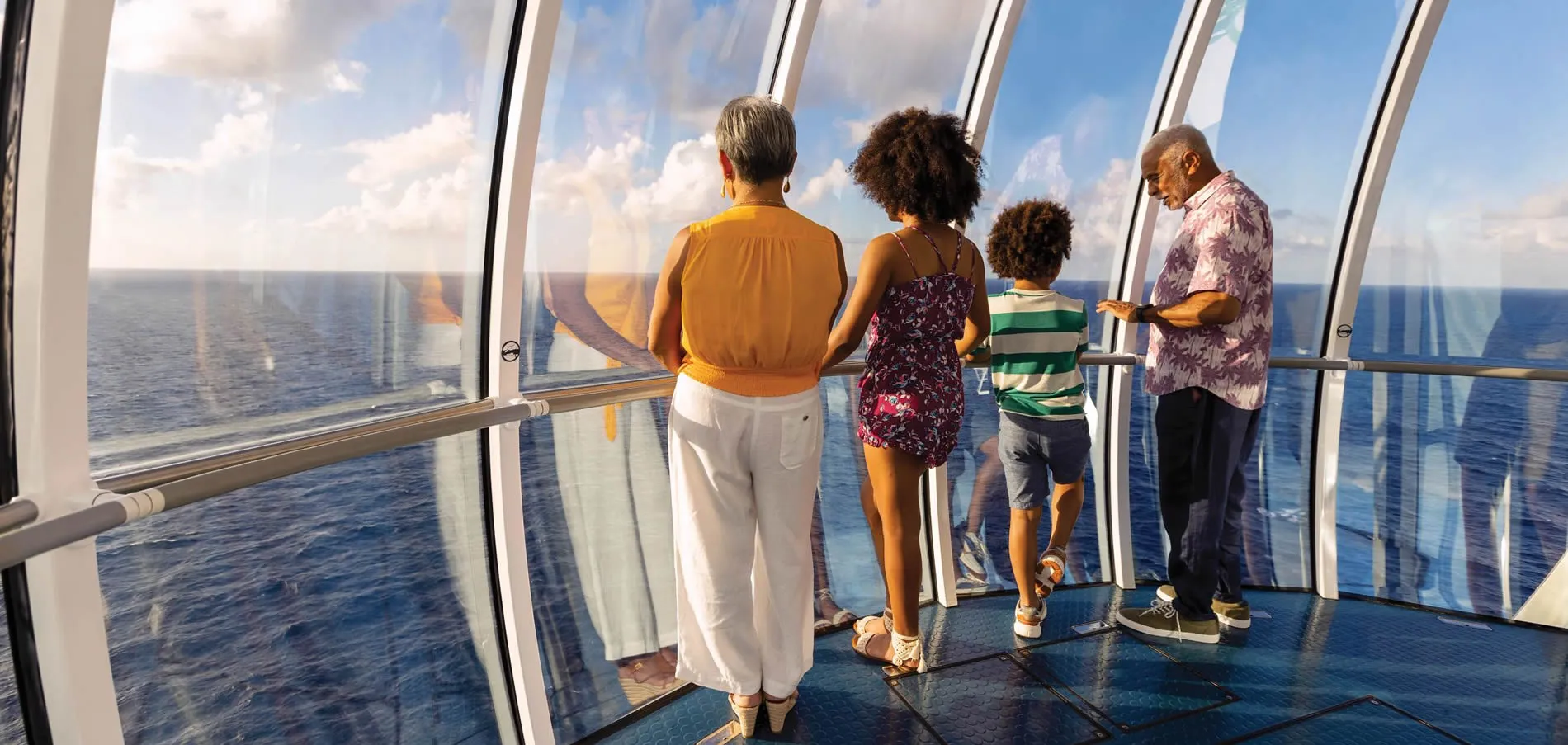 Family enjoying ocean view from cruise ship's panoramic windows