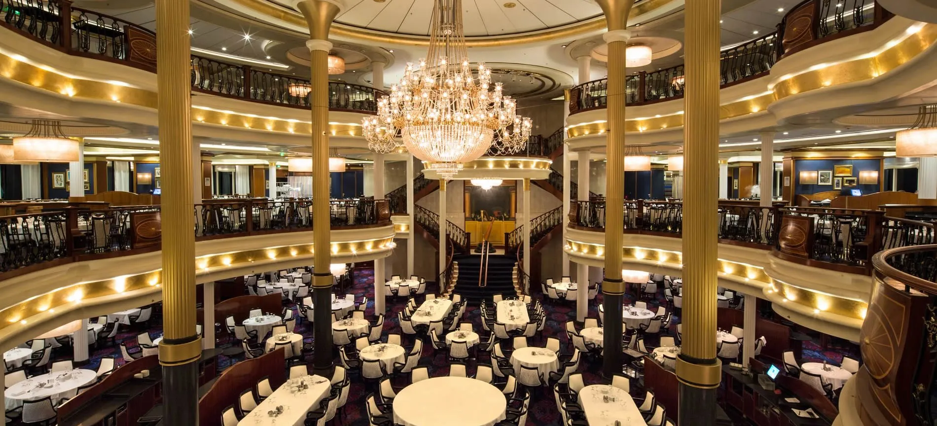 Elegant multi-level cruise ship dining room with grand crystal chandelier
