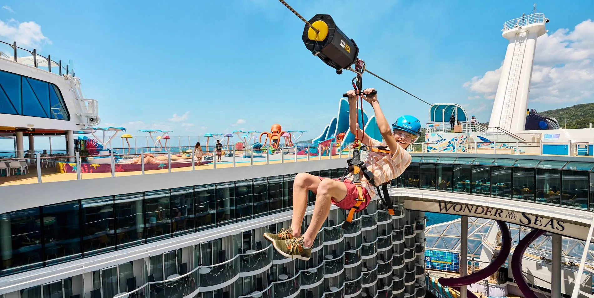 Cruise ship passenger ziplining high above the deck of Wonder of the Seas