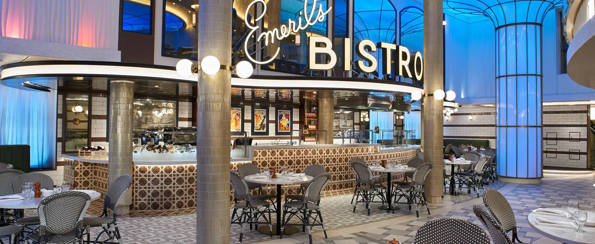 Emerils Bistro interior with stylish decor, tables, and blue lighting