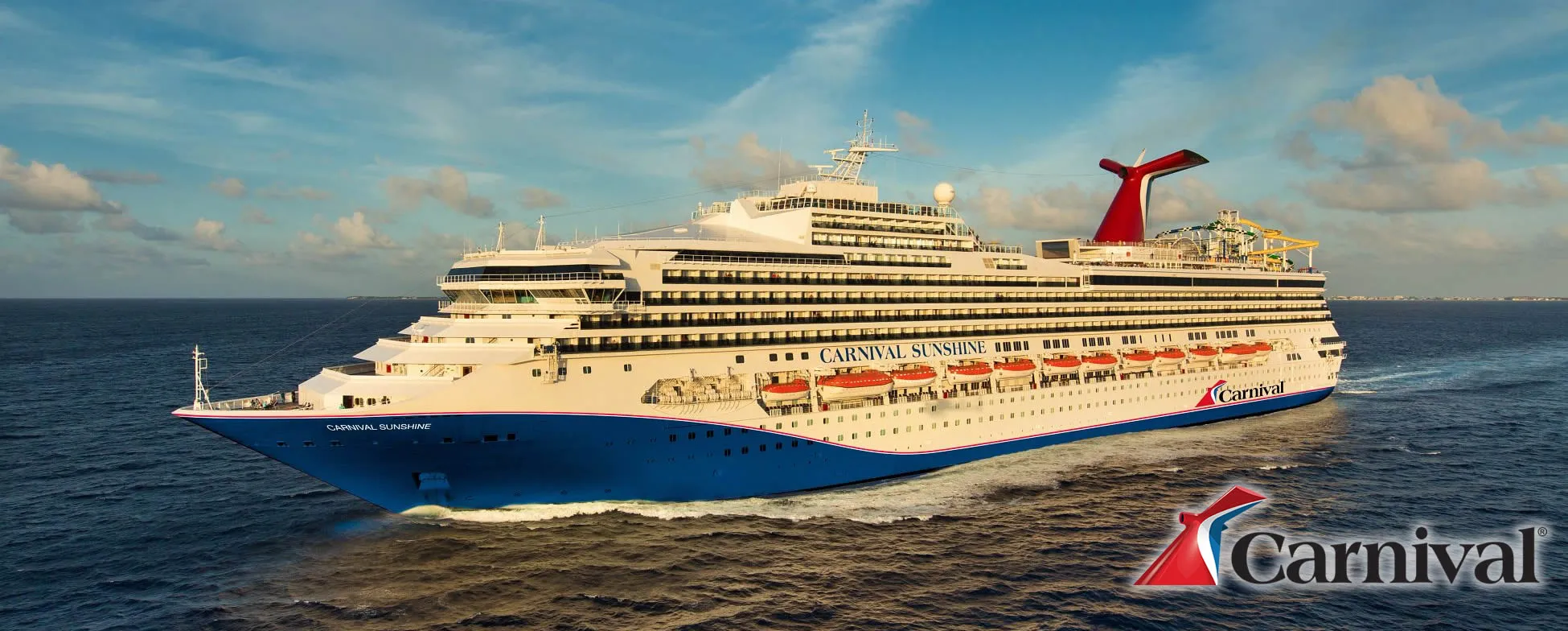 Carnival Sunshine cruise ship sailing on blue ocean with cloudy sky