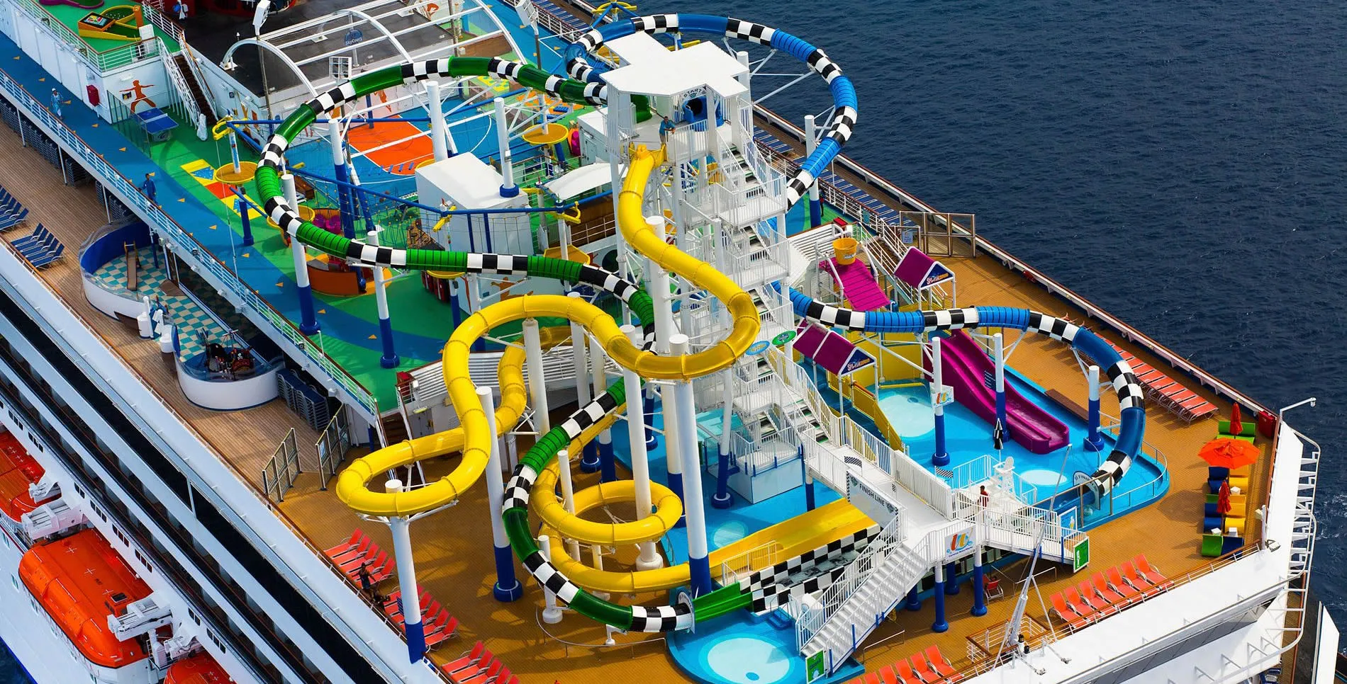 Colorful water slides and pools on the deck of a cruise ship