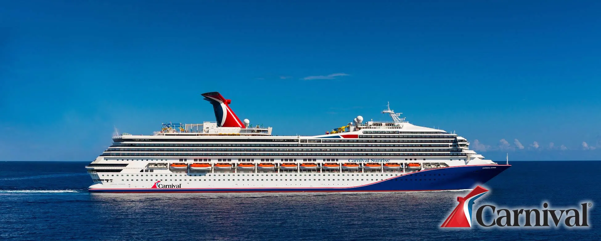 Carnival cruise ship sailing on blue ocean with clear sky