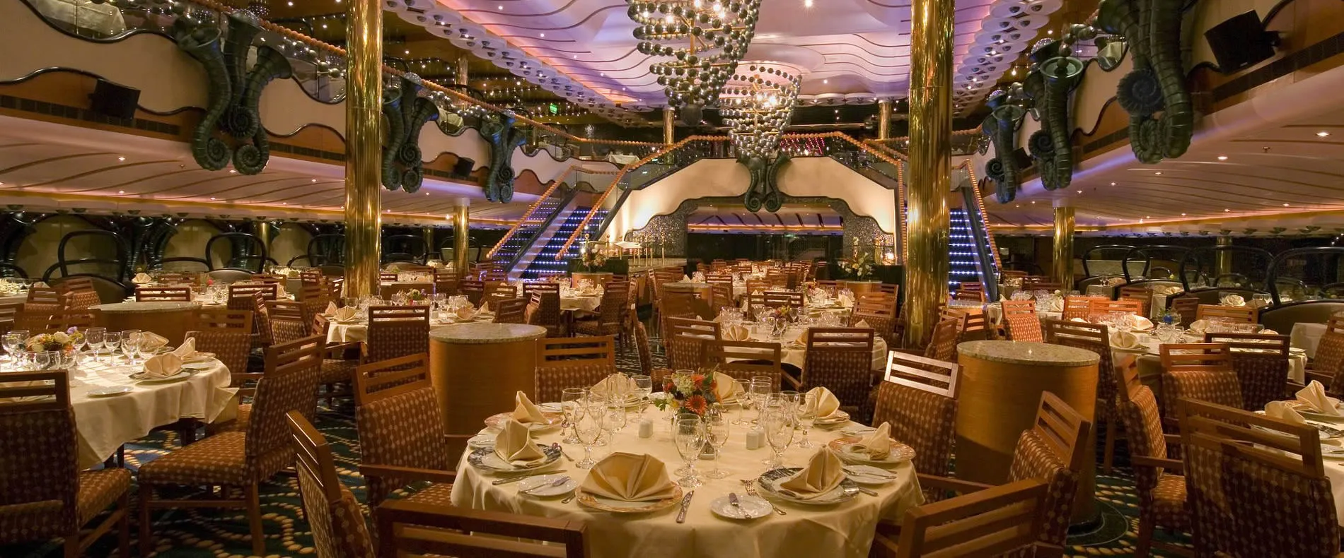 Elegant cruise ship dining room with chandeliers and formal table settings