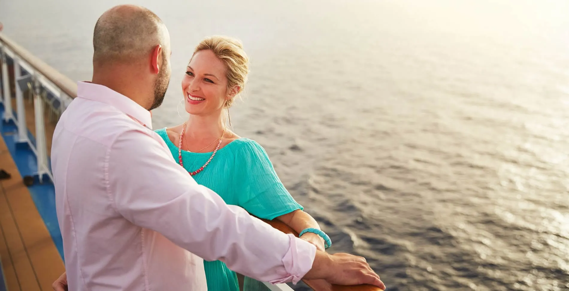 Couple enjoying romantic moment on cruise ship deck at sunset