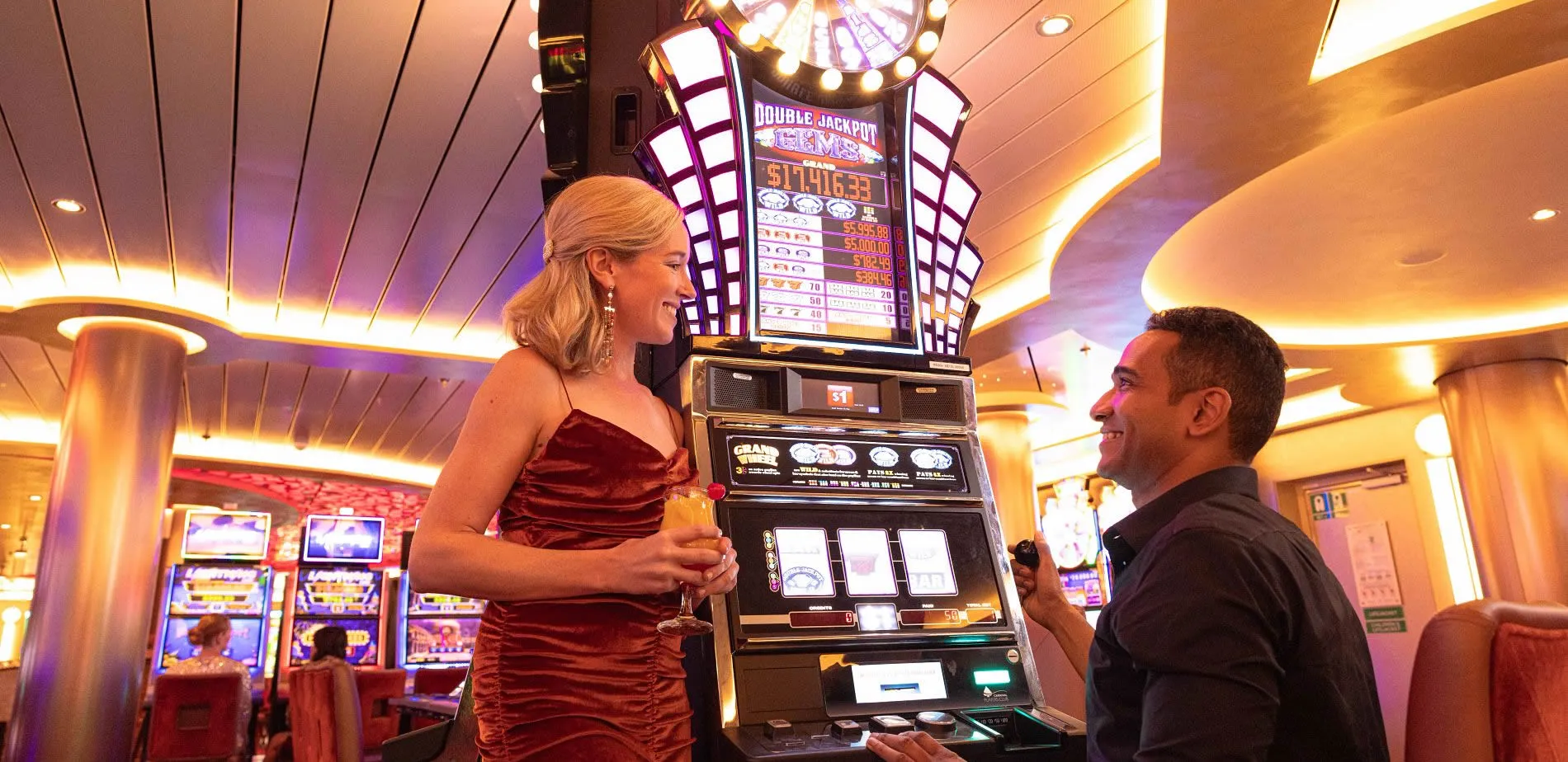 Dressed-up couple near casino slot machine with large jackpot display