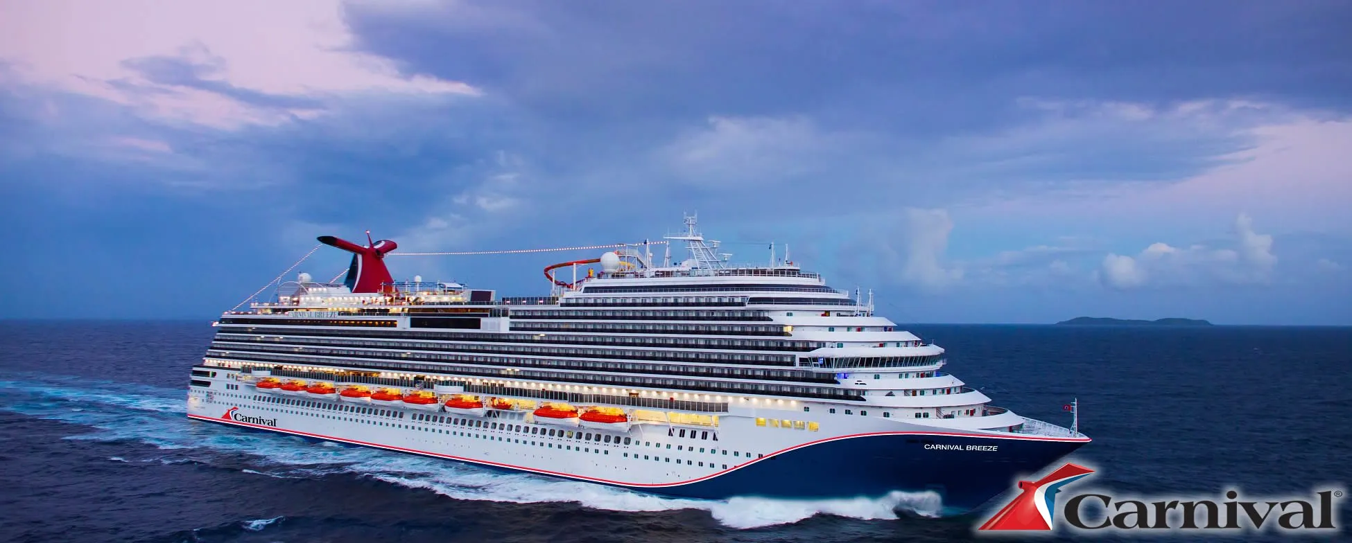 Carnival Breeze cruise ship sailing on blue ocean with cloudy sky