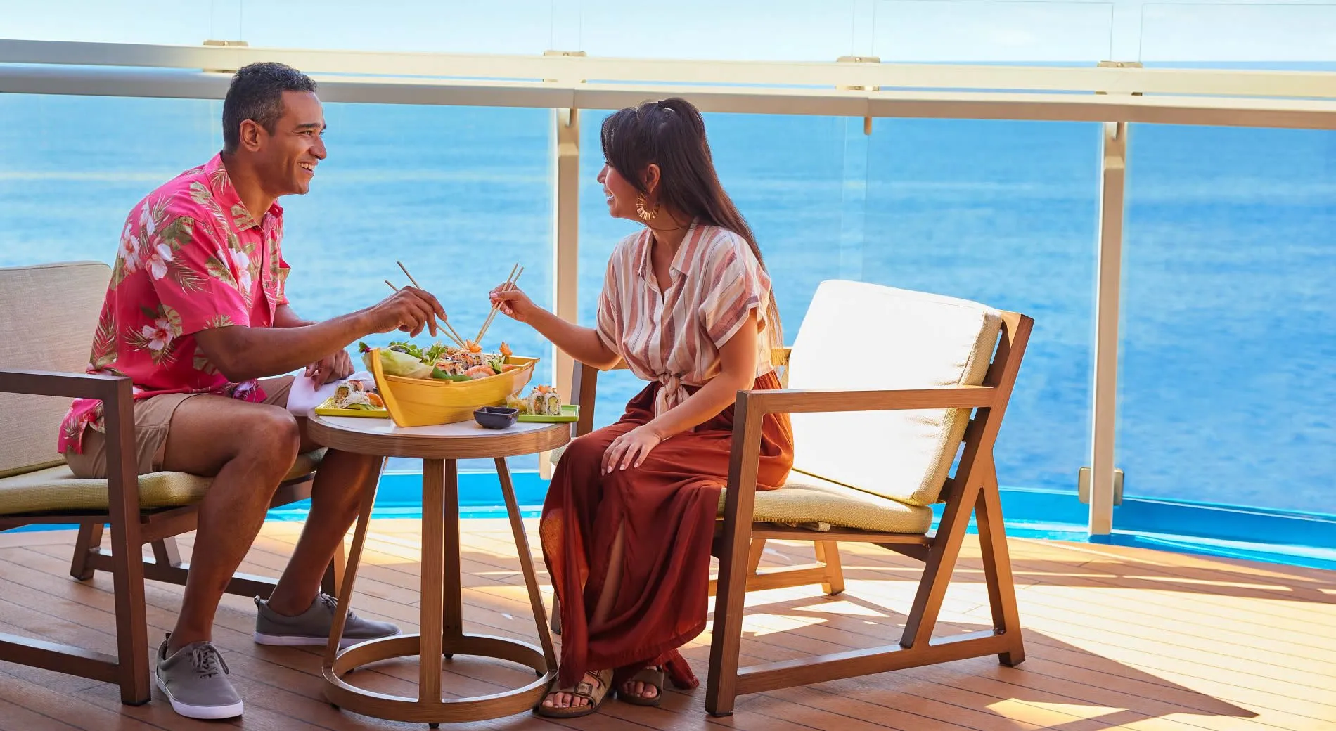 Couple enjoying meal on cruise ship balcony with ocean view