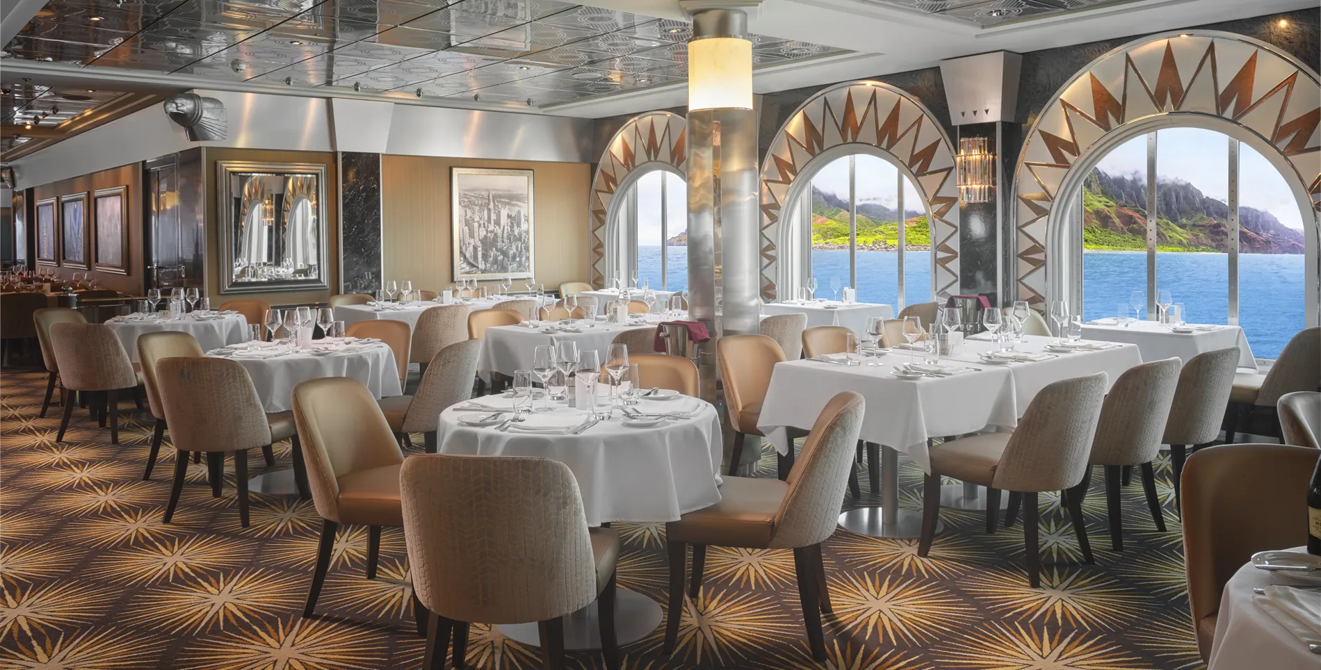Elegant dining room with ocean view, white tablecloths, and coastal landscape