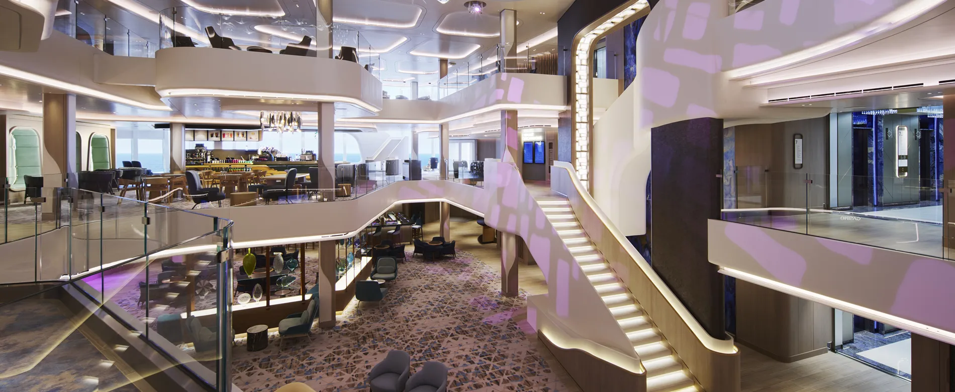 Modern cruise ship interior with elegant lounge, bar, and illuminated staircase