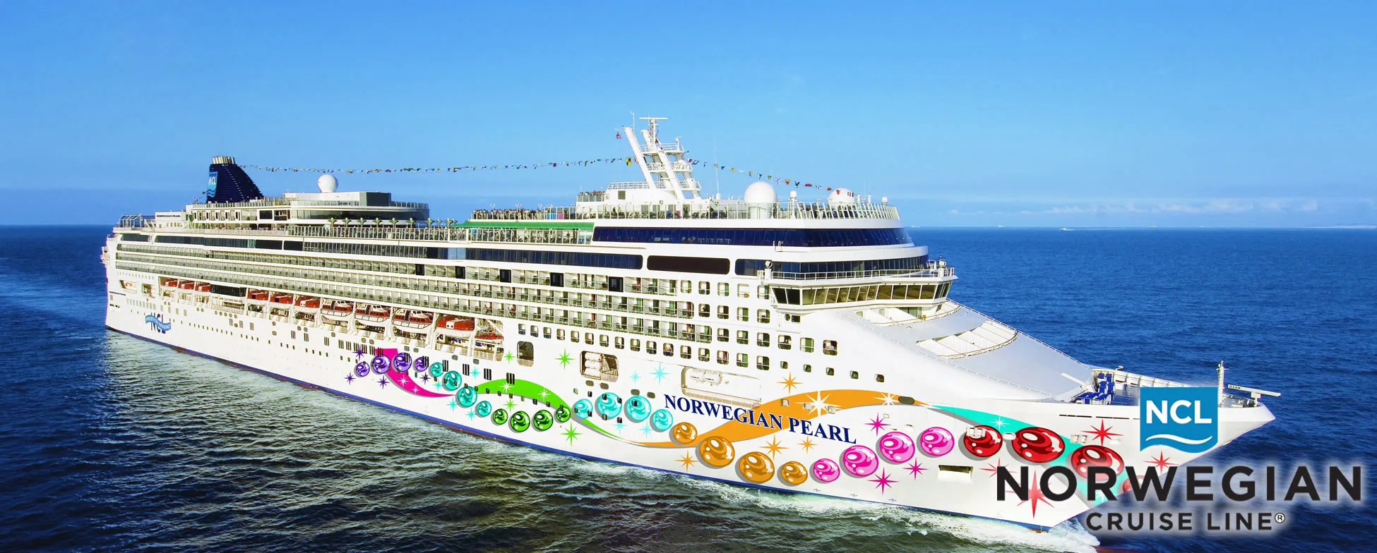 Norwegian Pearl cruise ship sailing on blue ocean with colorful decorations