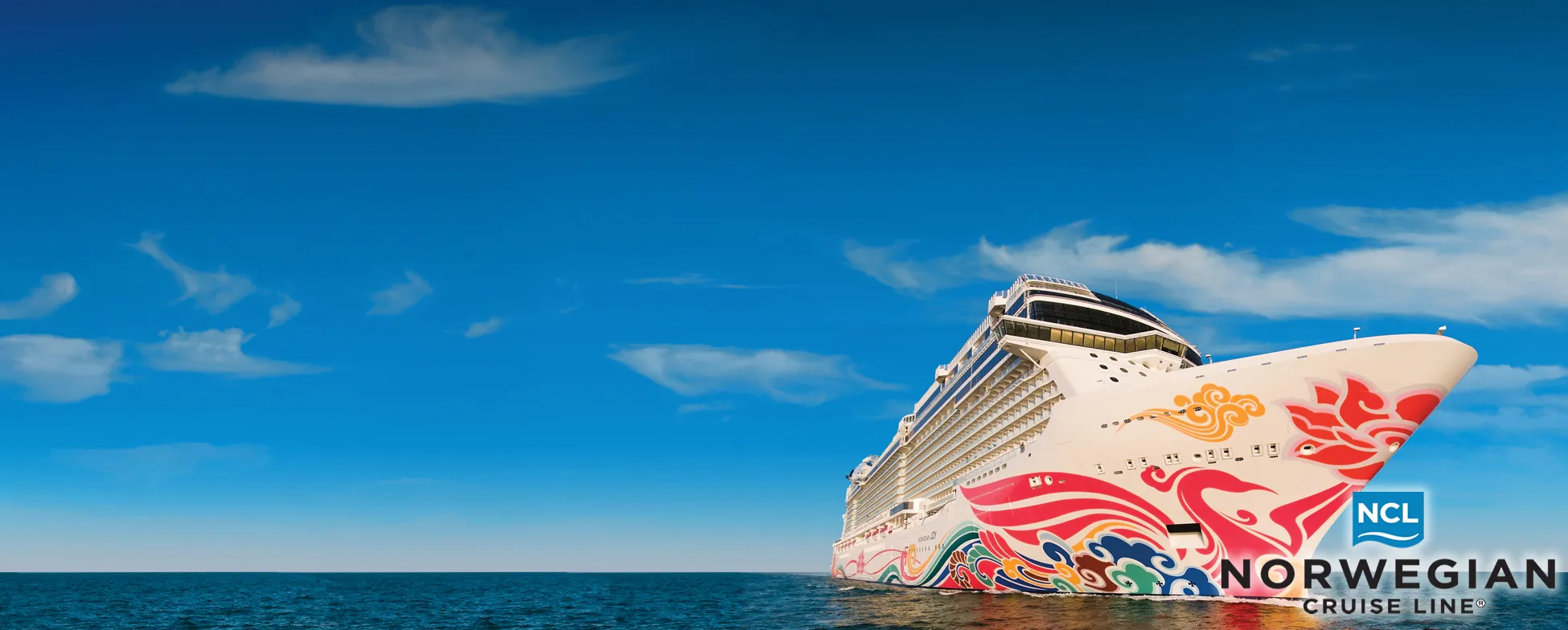 Colorful Norwegian Cruise Line ship sailing on blue ocean under clear sky