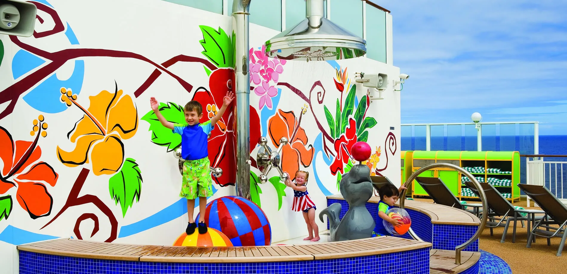 Children playing on colorful cruise ship deck with beach balls and sculpture