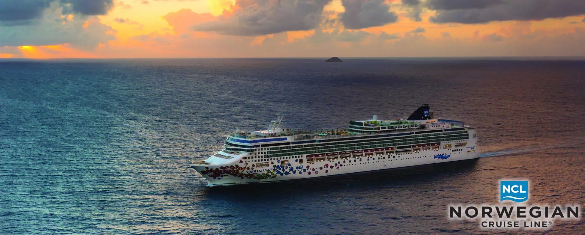 Norwegian Cruise Line ship sailing on ocean at colorful sunset