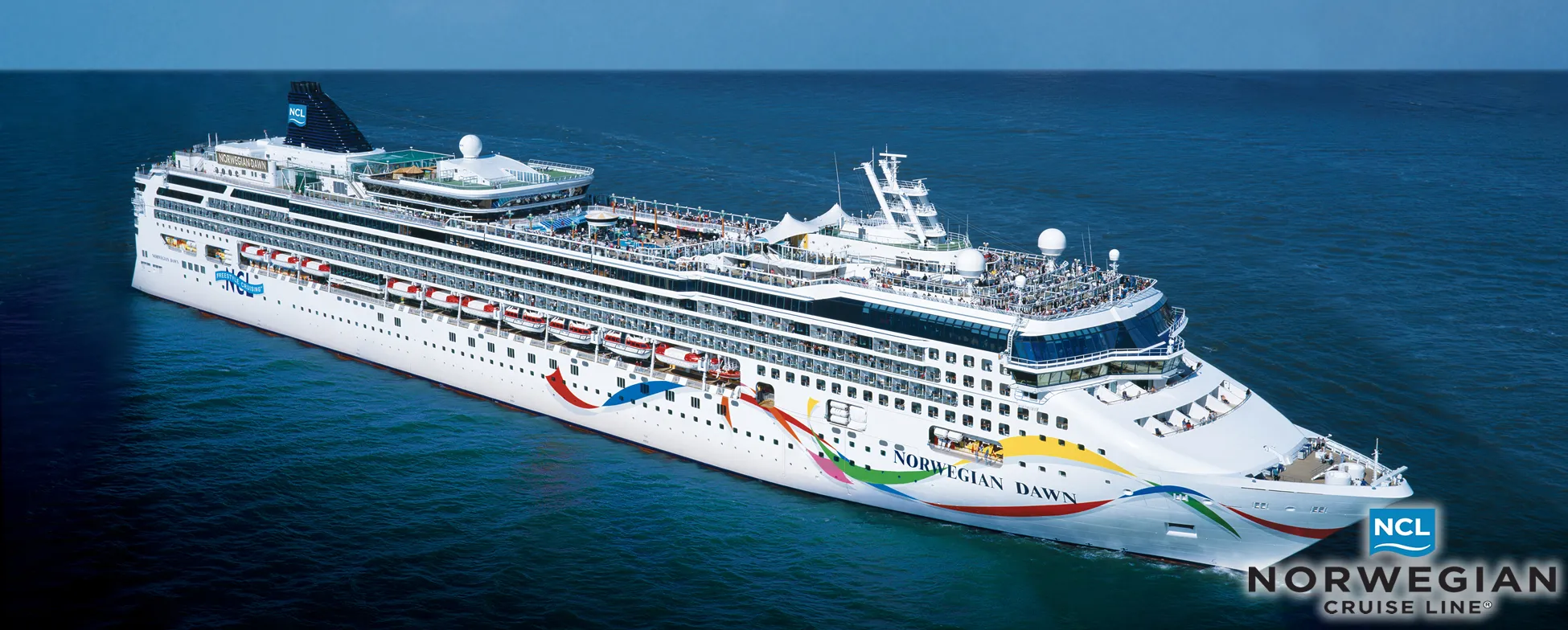 Norwegian Dawn cruise ship sailing on blue ocean with colorful design