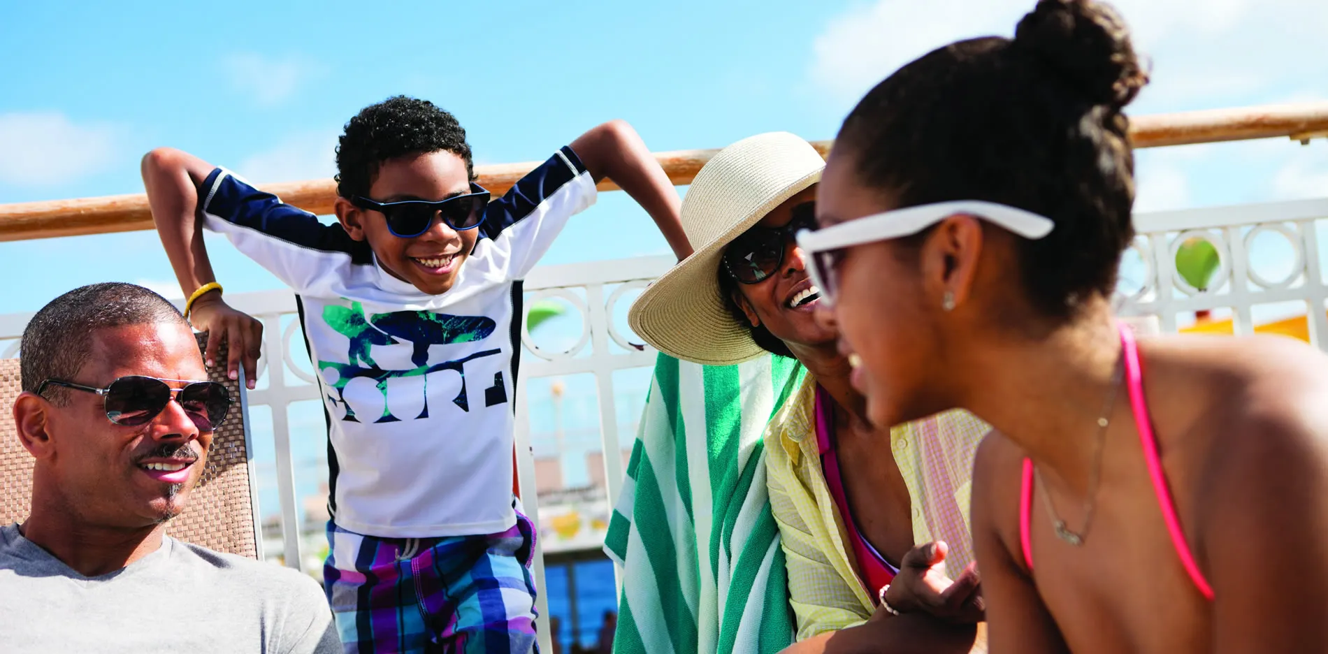 Happy family enjoying sunny day together on cruise ship deck