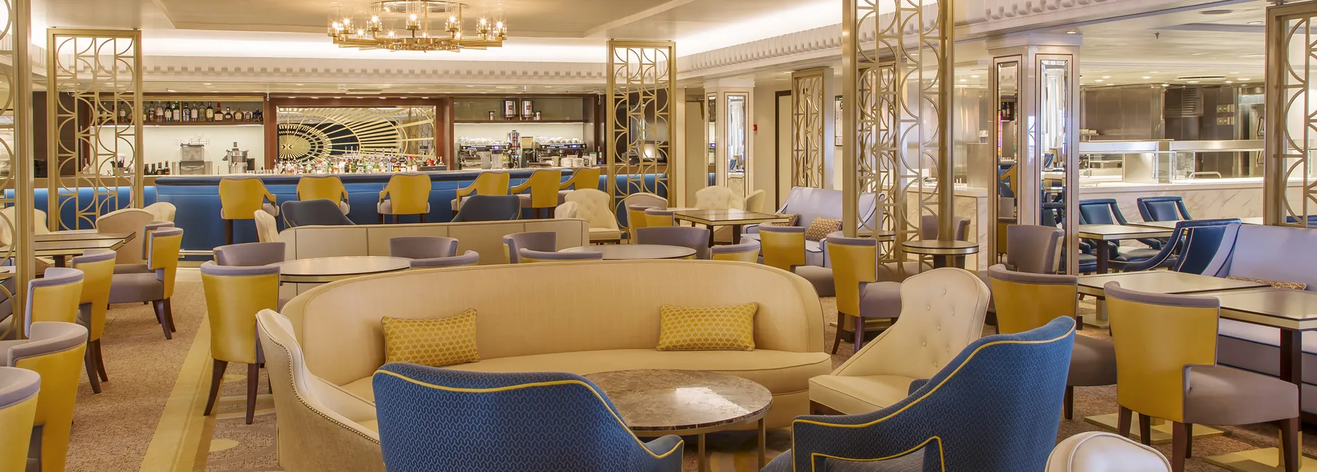 Elegant lounge with yellow and blue chairs, bar, and stylish art deco design