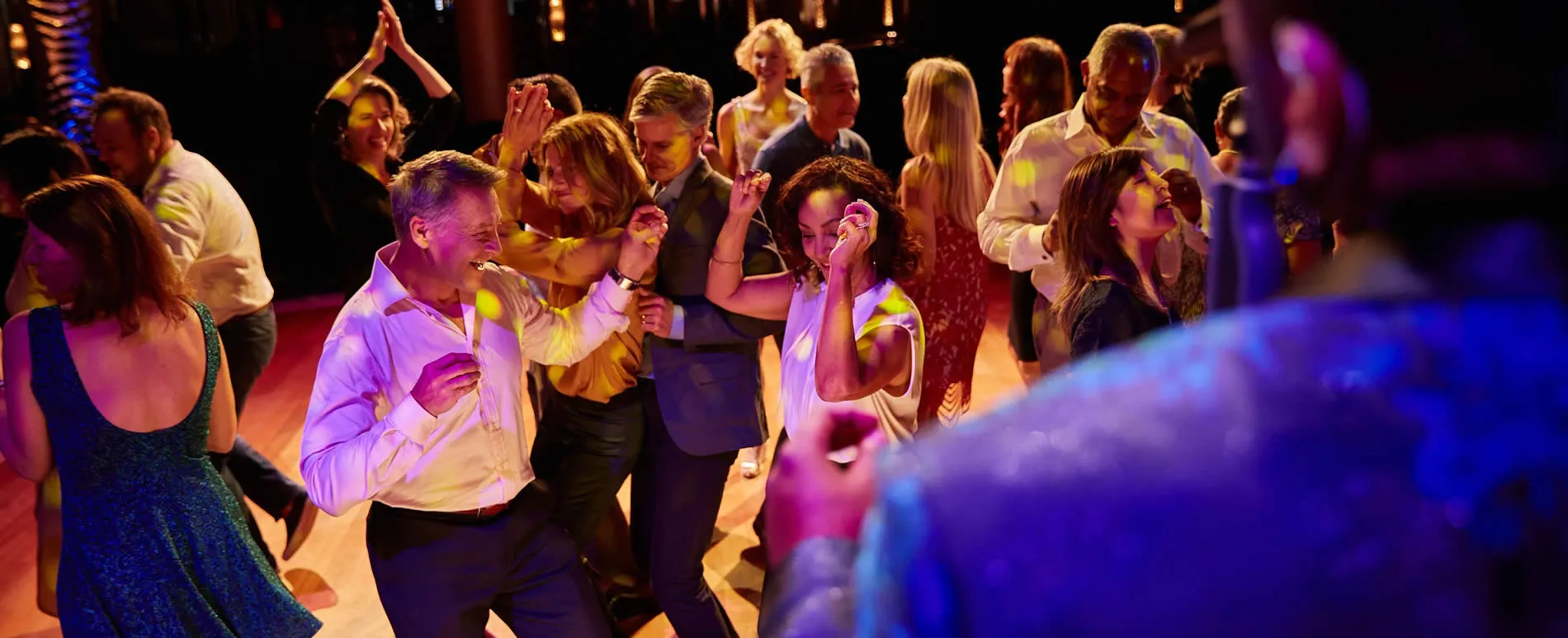Joyful people dancing and celebrating at a vibrant evening party