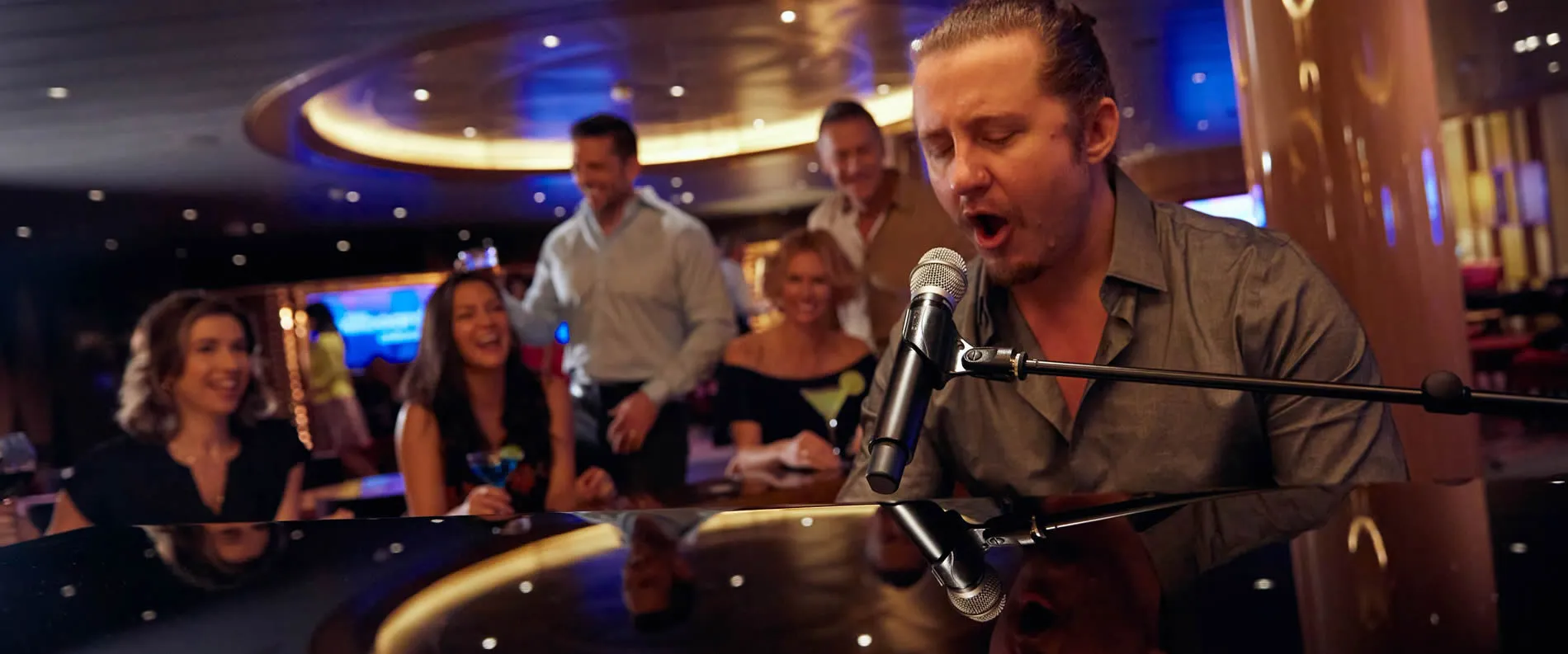 Musician performing passionately at piano in stylish lounge with attentive audience