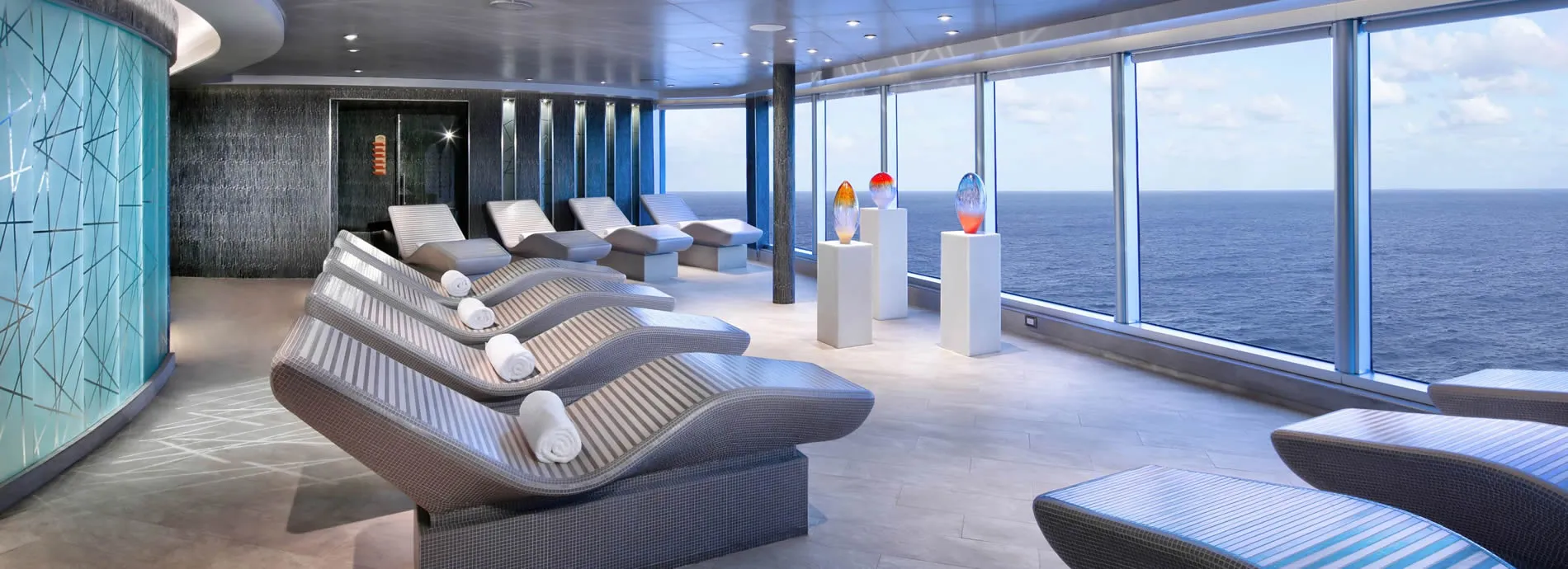 Luxurious cruise ship spa with ocean view and ergonomic loungers